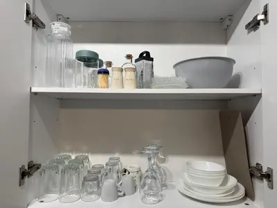 a cupboard filled with dishes and glass bottles at Cozy Homes Slivnitsa Studios in Sofia