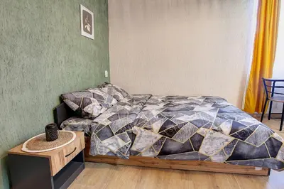 a bedroom with a bed and a table at Cozy Homes Slivnitsa Studios in Sofia