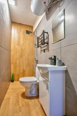 a bathroom with a white toilet and a sink at Cozy Homes Slivnitsa Studios in Sofia