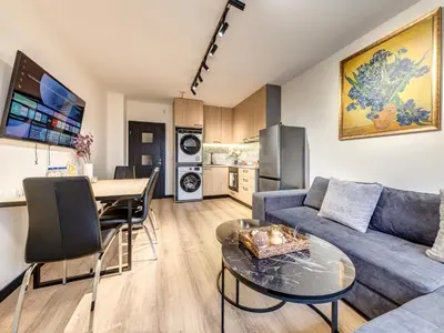a living room with a couch and a table at 1BD Mountain Getaway in Pamporovo with Parking By Flat Mаnager in Pamporovo