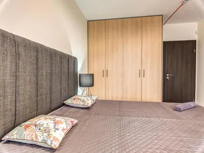 a bedroom with a large bed with two pillows at 1BD Mountain Getaway in Pamporovo with Parking By Flat Mаnager in Pamporovo