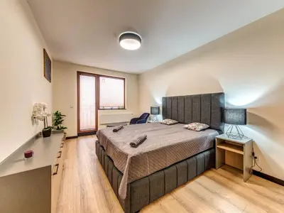 a bedroom with a large bed and a desk at 1BD Mountain Getaway in Pamporovo with Parking By Flat Mаnager in Pamporovo