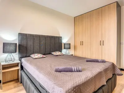 a bedroom with a large bed with two pillows on it at 1BD Mountain Getaway in Pamporovo with Parking By Flat Mаnager in Pamporovo