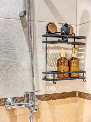 a bathroom sink with two shelves next to a shower at 1BD Mountain Getaway in Pamporovo with Parking By Flat Mаnager in Pamporovo