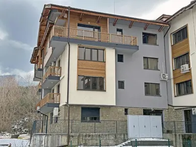 an apartment building with a balcony on the side at New! Park Lane Bansko Residences in Bansko