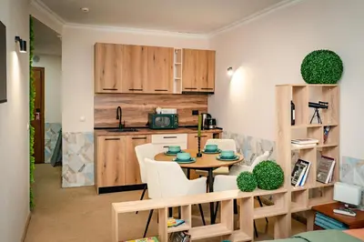 a kitchen and dining room with a table and chairs at Bansko Peak Apartments 102 in Bansko