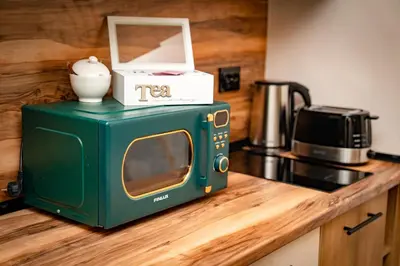 a green microwave sitting on top of a kitchen counter at Bansko Peak Apartments 102 in Bansko