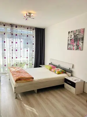 a bedroom with a bed and a window at Cozy apartment kids friendly in Sofia