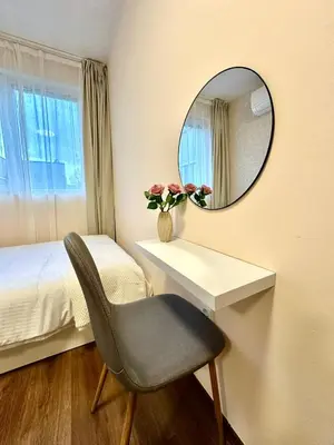 a bedroom with a mirror and a chair and a bed at Ikigai Living - Cozy Studio in Studentski Grad in Sofia