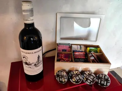 a bottle of wine next to a box of chocolates at Bansko Peak Apartments 116 in Bansko