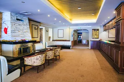 a hotel room with a lobby with a fireplace at Bansko Peak Apartments 116 in Bansko