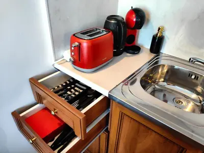 a kitchen with a toaster on a counter next to a sink at Bansko Peak Apartments 116 in Bansko