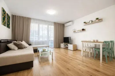 a living room with a couch and a table at Prime Apartment Seven & Parking in Plovdiv
