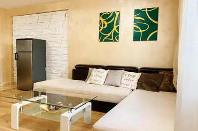 a living room with a couch and a glass table at Prime Apartment Seven & Parking in Plovdiv