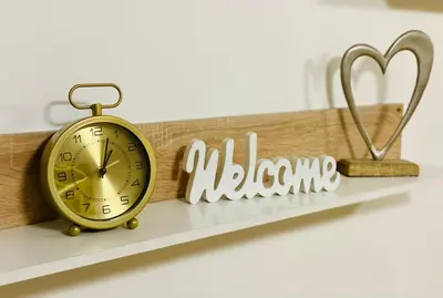 a shelf with a clock and a sign that reads jealous at Prime Apartment Seven & Parking in Plovdiv
