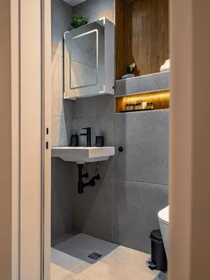 a bathroom with a sink and a toilet at Stylish New High-End 3BR Apt on Vitoshka Blvd in Sofia