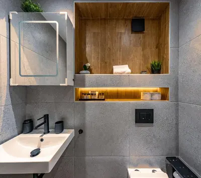 a bathroom with a sink and a mirror at Stylish New High-End 3BR Apt on Vitoshka Blvd in Sofia