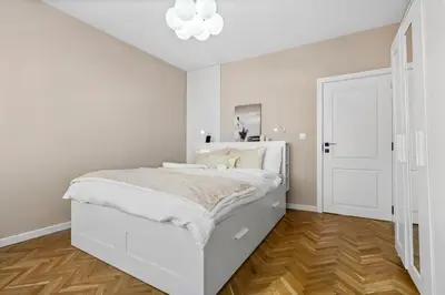 a white bedroom with a white bed and a white door at Kapana - a 106m2 Flat right on the Pedestrian Street in Plovdiv