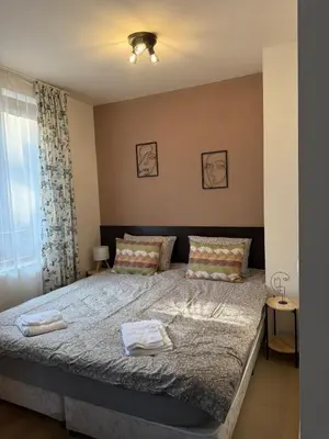 a bedroom with a bed with two towels on it at Panorama Studio Home2Host in Bansko