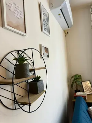 a shelf in a room with two potted plants at Panorama Studio Home2Host in Bansko