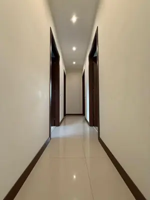 an empty hallway with doors and a tile floor at Golf view in Razlog