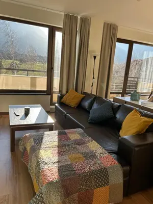 a living room with a couch and a table at Golf view in Razlog