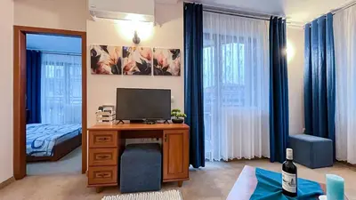 a room with a desk with a television and a bed at Bansko Peak Apartments 106 in Bansko