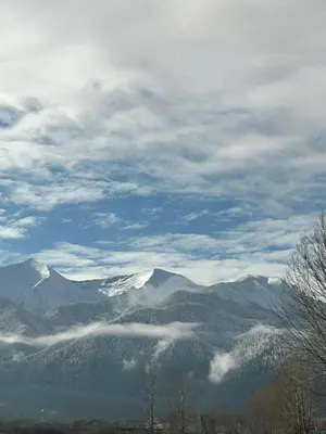 a view of a mountain range with snow capped mountains at Green Elephant in Razlog