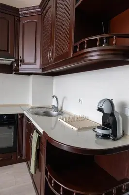a kitchen with a sink and a telephone on a counter at Апартамент в центъра на Хисаря in Hisarya