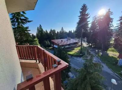 a view of a house from a balcony at Flora Residence Cozy Apartments in Borovets