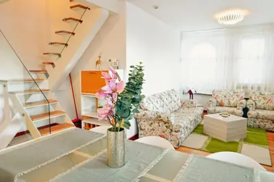 a living room with a vase of flowers on a table at GOLF Queen MARIA Apartment Home2Host in Razlog