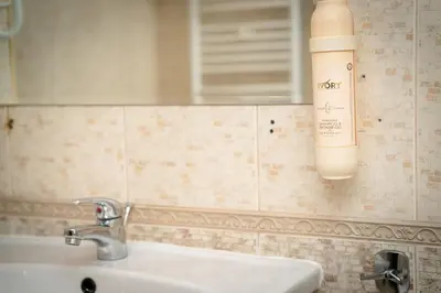 a bathroom with a sink and a blow dryer on the wall at Bansko Peak Apartments 304 in Bansko