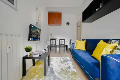 a living room with a blue couch and a table at Cozy Central 1BD Apartment in Sofia