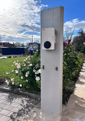 a white box sitting on a sidewalk next to flowers at Vital Hotel in Sofia
