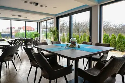 a dining room with a large table and chairs at Vital Hotel in Sofia