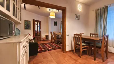 a living room with a table and a dining room at PORTALA Urban Lodge in Rila