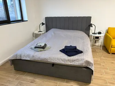 a bed with two shirts on it in a bedroom at Парксайд Лейн Студио in Bansko