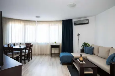 a living room with a couch and a table at Sunny & Modern 1BR Apartment in Sofia