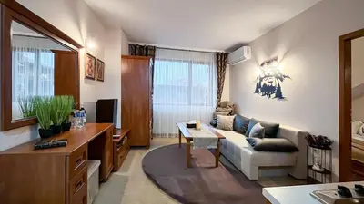 a living room with a couch and a table at Bansko Peak Apartments 508 in Bansko