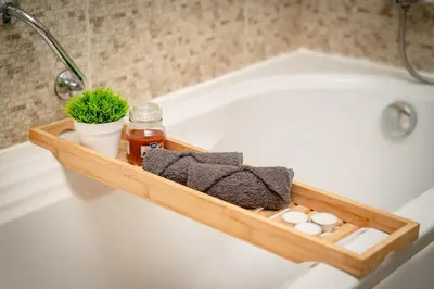 a wooden bathtub tray with towels and a plant at Bansko Peak Apartments 508 in Bansko