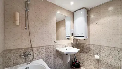 a bathroom with a sink and a toilet and a mirror at Bansko Peak Apartments 508 in Bansko