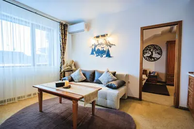 a living room with a couch and a table at Bansko Peak Apartments 508 in Bansko