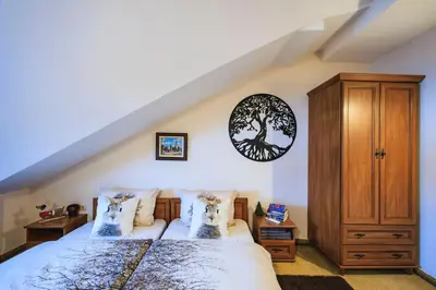 a bedroom with a bed and a wooden cabinet at Bansko Peak Apartments 508 in Bansko