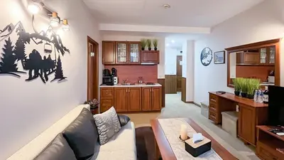 a living room with a couch and a kitchen at Bansko Peak Apartments 508 in Bansko