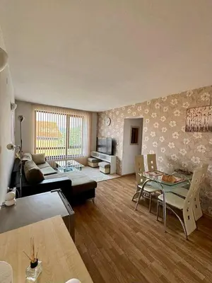a living room with a couch and a table at Yeti Complex in Bansko