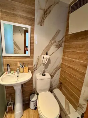 a bathroom with a white toilet and a sink at Yeti Complex in Bansko