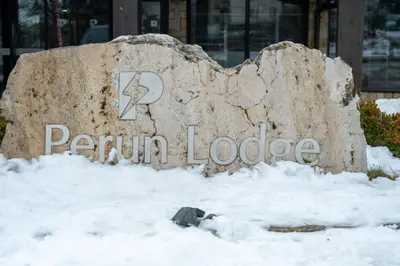 a sign for a pruitt lobby in the snow at Private Ap in Perun Lodge Ski Escape & Spa in Bansko