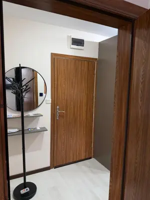 a room with a wooden door and a mirror at Elizi2 winter apartments Pamporovo in Pamporovo