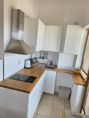 a kitchen with white cabinets and a counter top at Balcony and Mountain View 7 min Walk to Ski Gondola in Bansko