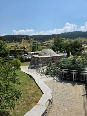 a stone building with a dome on top of it at Balcony and Mountain View 7 min Walk to Ski Gondola in Bansko